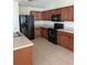 Well-equipped kitchen with stainless steel appliances, light countertops, and dark wood cabinets at 281 Palmetto Glen Dr., Myrtle Beach, SC 29588