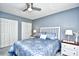 Bedroom with bright-blue walls, ceiling fan, white trim, and two closets at 3105 Robyn Ct., Little River, SC 29566