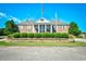 Clubhouse featuring brick facade, lush landscaping, and stately columns at 3105 Robyn Ct., Little River, SC 29566