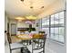Bright dining area features a round table with four chairs and a decorative chandelier, illuminated by natural light at 3105 Robyn Ct., Little River, SC 29566