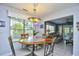 Inviting dining area with table, chairs, pendant lighting, and a glimpse into the cozy living room at 3105 Robyn Ct., Little River, SC 29566