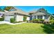 Well-manicured front lawn with flower beds and lush green shrubs giving the exterior pleasant curb appeal at 3105 Robyn Ct., Little River, SC 29566