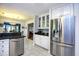 Kitchen features stainless steel appliances and granite countertops with a view into the dining and living areas at 3105 Robyn Ct., Little River, SC 29566