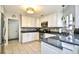 Well-lit kitchen featuring custom white cabinets, stone countertops, tile backsplash, and stainless steel appliances at 3105 Robyn Ct., Little River, SC 29566