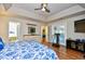 Spacious main bedroom featuring wood floors, a tray ceiling, and access to the en-suite bathroom at 3105 Robyn Ct., Little River, SC 29566
