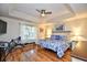 Bright main bedroom featuring tray ceilings, wood floors, a ceiling fan, and natural light from the window at 3105 Robyn Ct., Little River, SC 29566