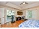 Bright main bedroom with wood floors, recessed lighting, a ceiling fan, and access to the sunroom at 3105 Robyn Ct., Little River, SC 29566