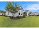 Backyard view, enhanced by beautiful landscaping and screened porch that adds a touch of elegance at 364 Palm Lakes Blvd., Little River, SC 29566