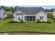 Backyard view, enhanced by beautiful landscaping and screened porch that adds a touch of elegance at 364 Palm Lakes Blvd., Little River, SC 29566