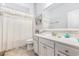 Bright bathroom with a single sink vanity, tile flooring, and a shower with a decorative curtain at 364 Palm Lakes Blvd., Little River, SC 29566