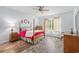 Bright bedroom features wood-look floors, ceiling fan, and natural light from a window with floral curtains at 364 Palm Lakes Blvd., Little River, SC 29566