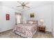 Cozy bedroom with patterned bedding, carpet flooring, and natural light from a window with floral curtains at 364 Palm Lakes Blvd., Little River, SC 29566