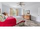 Bright bedroom features wood-look floors, ceiling fan, and natural light from a window with floral curtains at 364 Palm Lakes Blvd., Little River, SC 29566