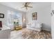 Cozy bedroom with large window, ceiling fan, and comfortable seating at 364 Palm Lakes Blvd., Little River, SC 29566