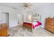 Bright bedroom features wood-look floors, ceiling fan, and an ensuite bathroom at 364 Palm Lakes Blvd., Little River, SC 29566