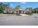 Clubhouse exterior with a welcoming entrance, landscaped gardens, and ample parking space at 364 Palm Lakes Blvd., Little River, SC 29566