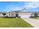 Charming single-story home with a well-manicured lawn, two-car garage, and nicely landscaped garden at 364 Palm Lakes Blvd., Little River, SC 29566