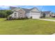 Well-maintained lawn complements this lovely single-story home, showcasing its appealing exterior and curb appeal at 364 Palm Lakes Blvd., Little River, SC 29566