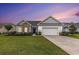 Charming single-story home with a well-manicured lawn, two-car garage, and nicely landscaped garden at 364 Palm Lakes Blvd., Little River, SC 29566