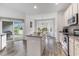 Open kitchen featuring granite countertops, island, stainless steel oven, and waterfront views at 364 Palm Lakes Blvd., Little River, SC 29566