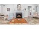 Cozy living room features a fireplace, comfortable seating, and a lovely view of the backyard at 364 Palm Lakes Blvd., Little River, SC 29566