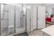 Modern glass enclosed shower with grab bar and built in seating next to the bedroom at 364 Palm Lakes Blvd., Little River, SC 29566