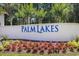 Palm Lakes community sign with colorful flowers, showcasing the neighborhood's welcoming entrance at 364 Palm Lakes Blvd., Little River, SC 29566