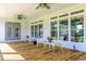 Relaxing back porch with ceiling fans, decorative chairs, and ample sunlight at 3718 Highway 931, Conway, SC 29526