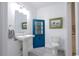 Bathroom featuring a pedestal sink, toilet, and a decorative blue cabinet at 3718 Highway 931, Conway, SC 29526