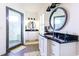 Modern bathroom with double vanities, black countertop, and walk-in shower with marble-like tiles at 3718 Highway 931, Conway, SC 29526