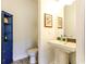 Powder room featuring a pedestal sink, toilet, and a blue cabinet at 3718 Highway 931, Conway, SC 29526