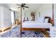 Bedroom with four-poster bed, hardwood floors, and ensuite bathroom access with closet at 3718 Highway 931, Conway, SC 29526