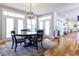 Dining room with hardwood floors, large windows, a decorative chandelier, and a table for four at 3718 Highway 931, Conway, SC 29526