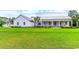 Charming single-story home with a sprawling green lawn and a welcoming front porch with rocking chairs at 3718 Highway 931, Conway, SC 29526