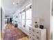 Bright hallway with large windows, hardwood floors, and stylish furnishings leading to various rooms at 3718 Highway 931, Conway, SC 29526