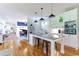 Open-concept kitchen with island seating and modern pendant lighting, adjacent to a living space at 3718 Highway 931, Conway, SC 29526