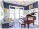 Cozy piano room with blue accent wall, comfortable seating, and bright natural light from large windows at 3718 Highway 931, Conway, SC 29526