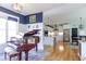 Open living space with piano, hardwood floors, and views into a modern kitchen and dining area at 3718 Highway 931, Conway, SC 29526