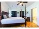 Main bedroom with hardwood floors, four poster bed, black closet doors, and ensuite bathroom at 3718 Highway 931, Conway, SC 29526