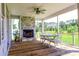Inviting screened porch with a fireplace, ceiling fan, and outdoor furniture at 3718 Highway 931, Conway, SC 29526