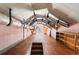 Unfinished attic space featuring exposed ductwork and a vintage wooden floor at 401 S Nichols St., Nichols, SC 29581