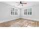 Sunlit bedroom with wood-look floors and shuttered windows at 401 S Nichols St., Nichols, SC 29581