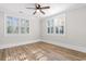 Bedroom features light wood floors, neutral walls, and shuttered windows at 401 S Nichols St., Nichols, SC 29581