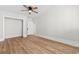 Bright bedroom with light-colored walls, wood-look floors, and a ceiling fan at 401 S Nichols St., Nichols, SC 29581