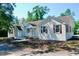 Classic white brick home featuring multiple entryways, chimney, and traditional design elements at 401 S Nichols St., Nichols, SC 29581