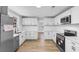 Open kitchen layout featuring new appliances, cabinets and backsplash at 401 S Nichols St., Nichols, SC 29581