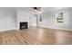 Cozy living room with a classic fireplace and wood floors, complemented by an inviting open doorway at 401 S Nichols St., Nichols, SC 29581