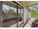 Large sliding glass door providing access to the balcony that overlooks lush greenery at 415 Ocean Creek Dr. # 2388, Myrtle Beach, SC 29572