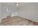 A bedroom with modern hardwood flooring, a ceiling fan, a closet, and access to the bathroom at 415 Ocean Creek Dr. # 2388, Myrtle Beach, SC 29572