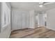 Bedroom featuring a window and spacious closet with wood-look floors at 415 Ocean Creek Dr. # 2388, Myrtle Beach, SC 29572
